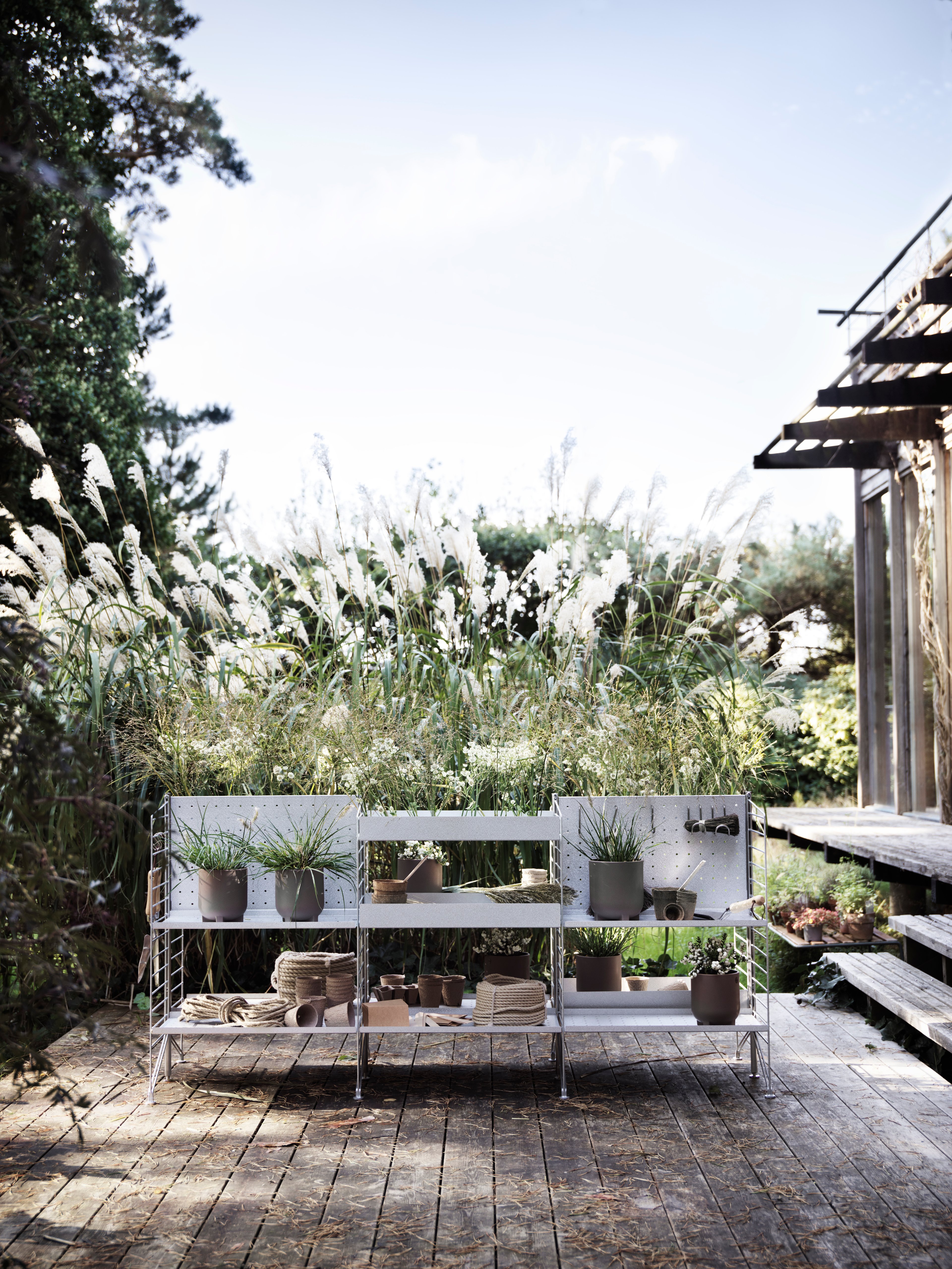 Free standing galvanized shelf intended for outdoor use. This larger three section combination is optimal for the larger balcony or patio. A mix of galvanized metal shelves with high and low edge give the shelf character and further storage possibilities. The galvanized material changes over time and leaves you with a beautiful patina.